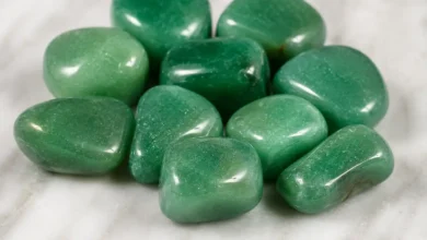 Polished green stones on smooth surface