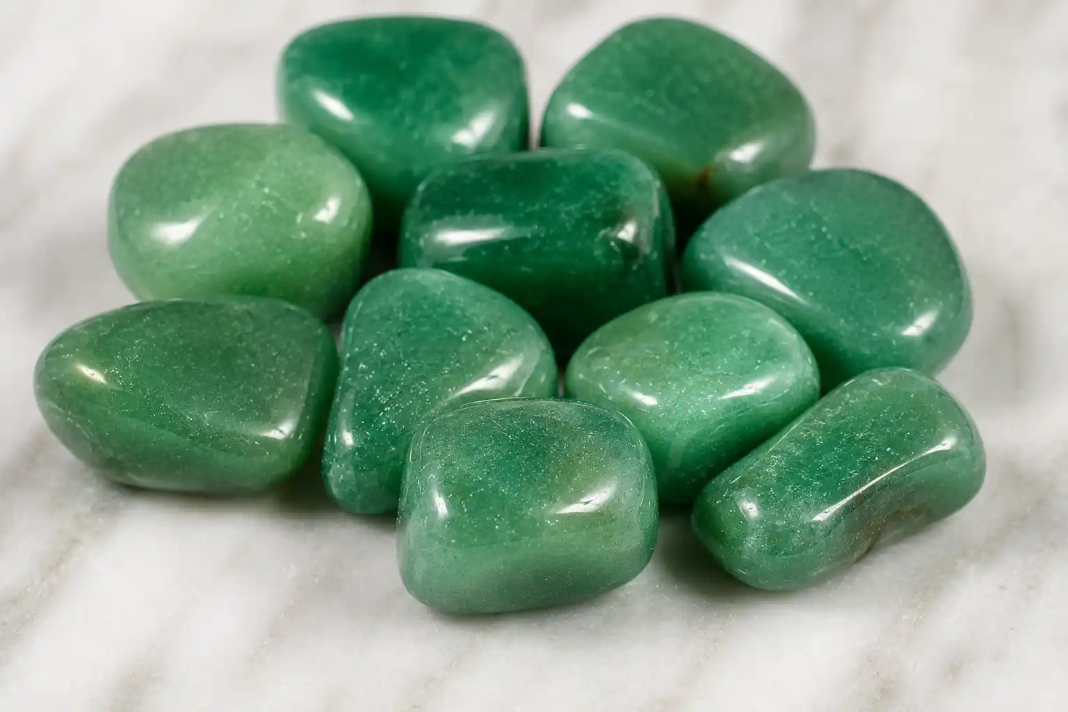 Polished green stones on smooth surface