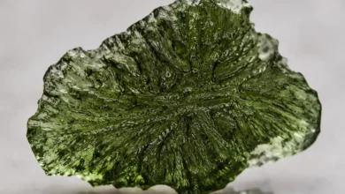 a forest-green moldavite tektite with etched surface
