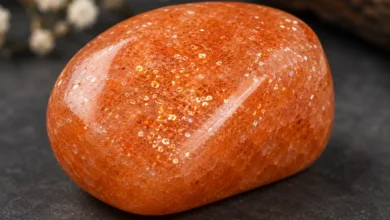 a warm orange sunstone with glittering copper shimmer