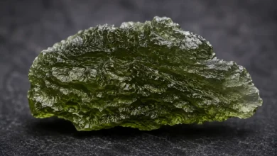 a piece of real moldavite showing etched natural surface texture