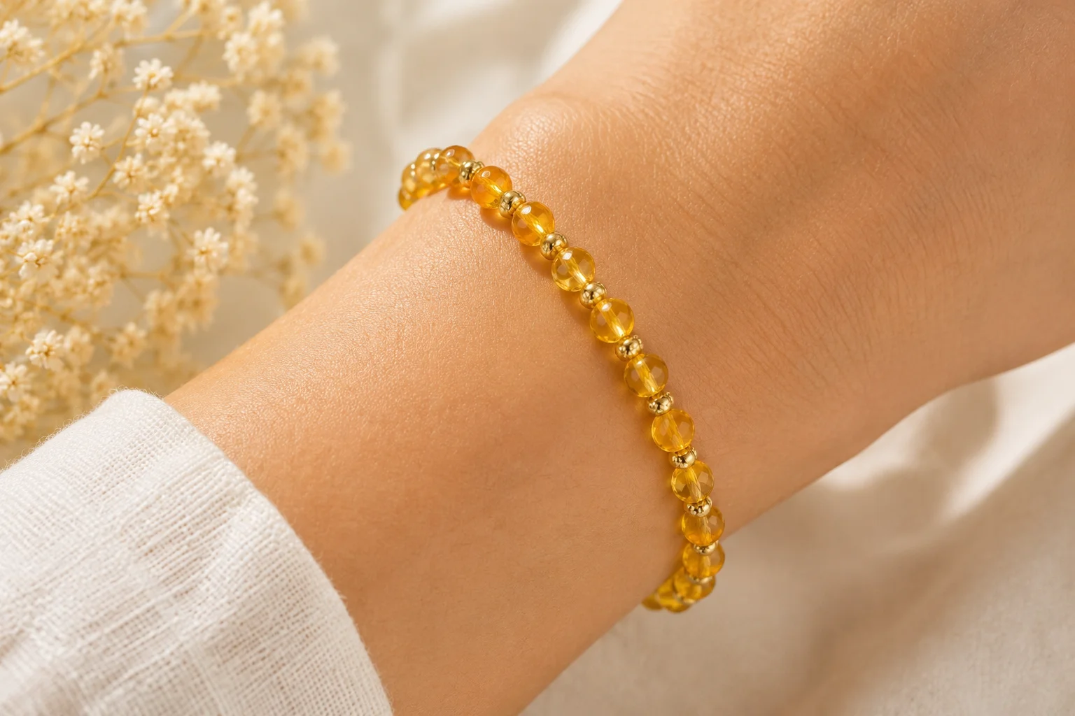a golden citrine bead bracelet on a wrist