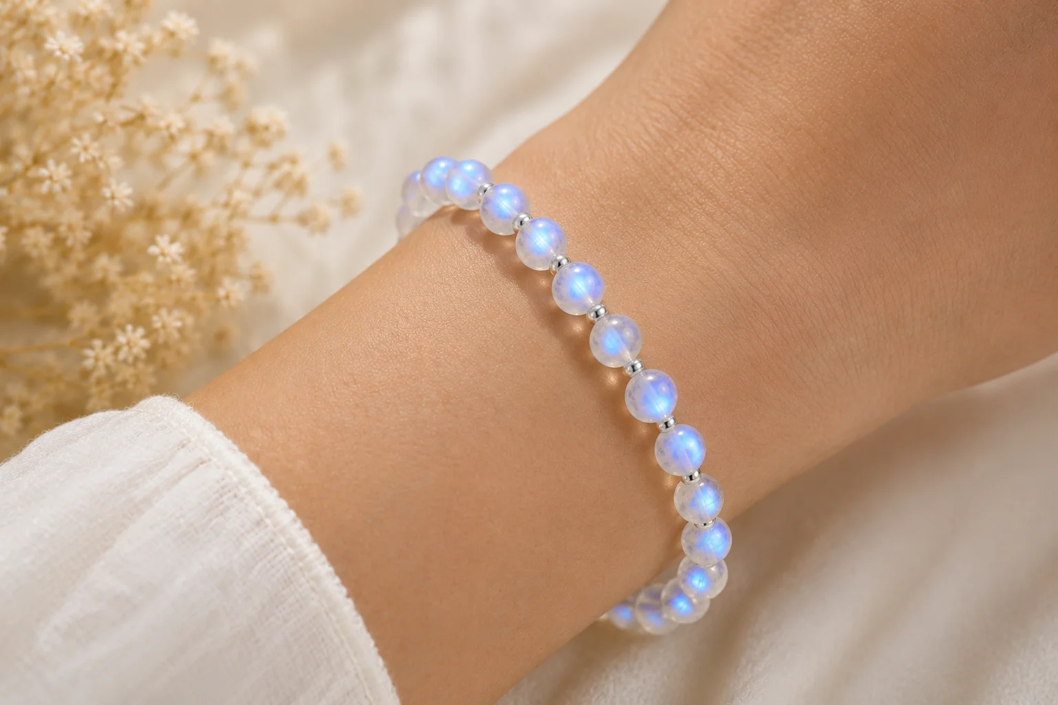 a moonstone bead bracelet glowing on a wrist