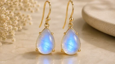 a pair of moonstone drop earrings glowing blue