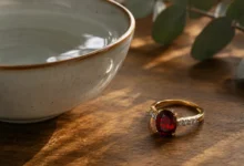 photo of a garnet ring beside a bowl of water