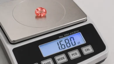 photo of a padparadscha sapphire on a gem scale