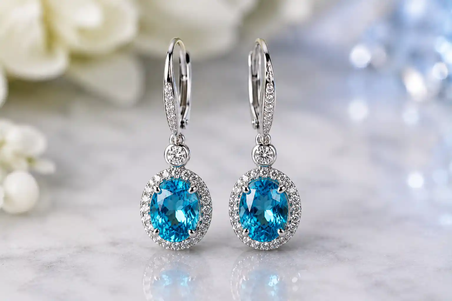 pair of blue zircon drop earrings sparkling near the face
