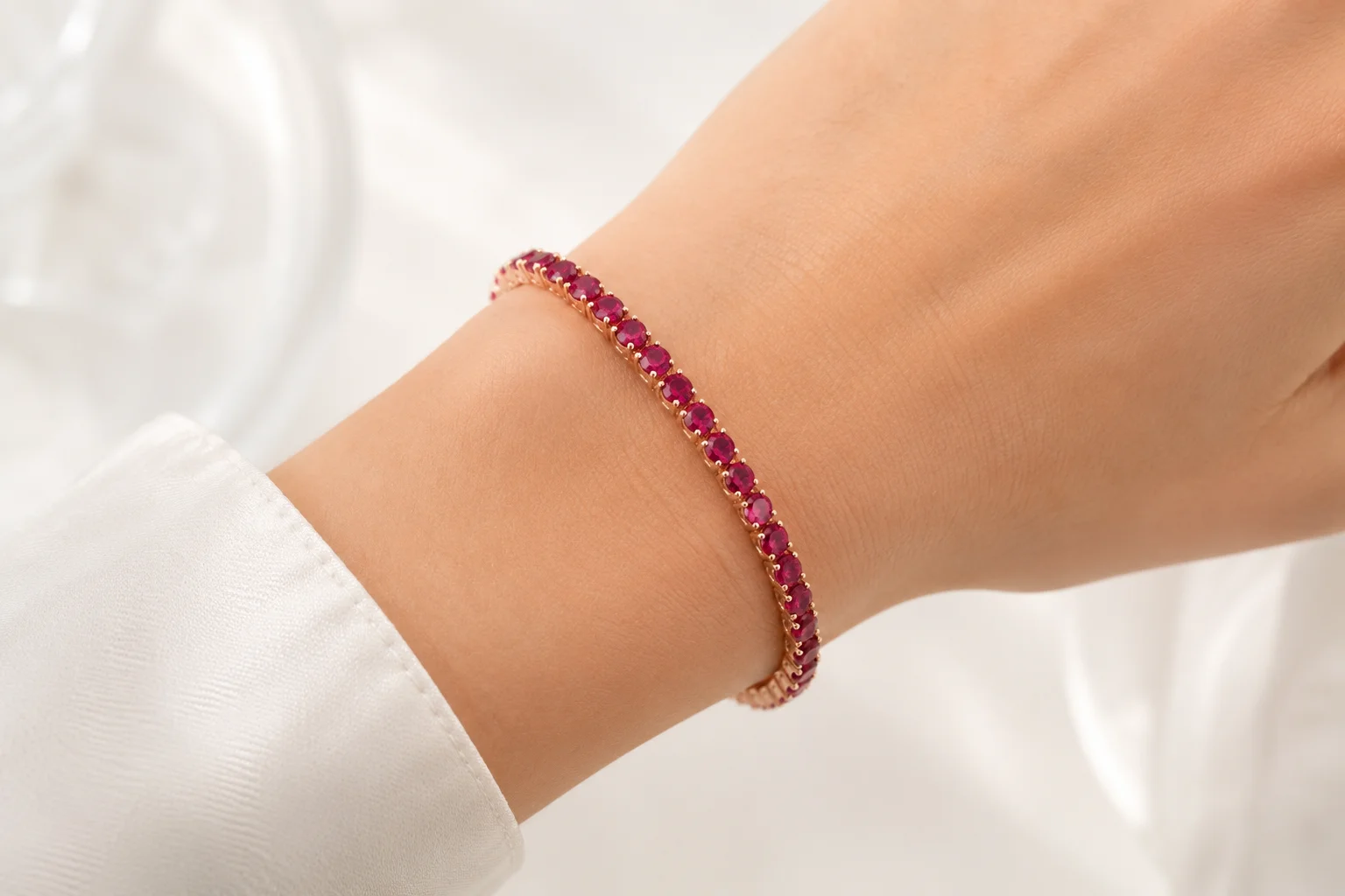 photo of a rhodolite tennis bracelet on a wrist