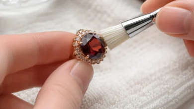 photo of garnet jewelry being cleaned with a soft brush