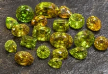 photo of loose sphene gems in green and gold
