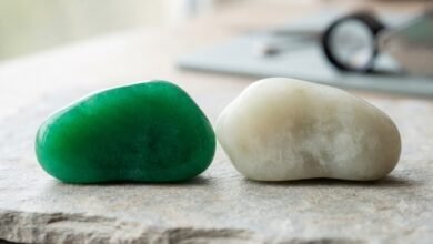 vivid green jadeite beside creamy nephrite jade